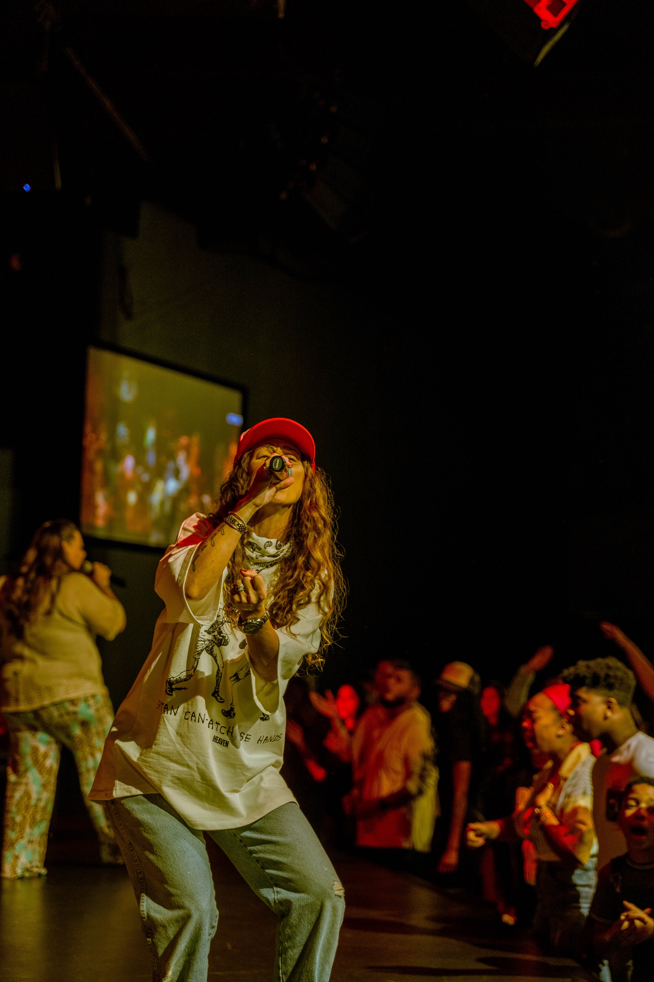 Performer singing on stage in front of a crowd
